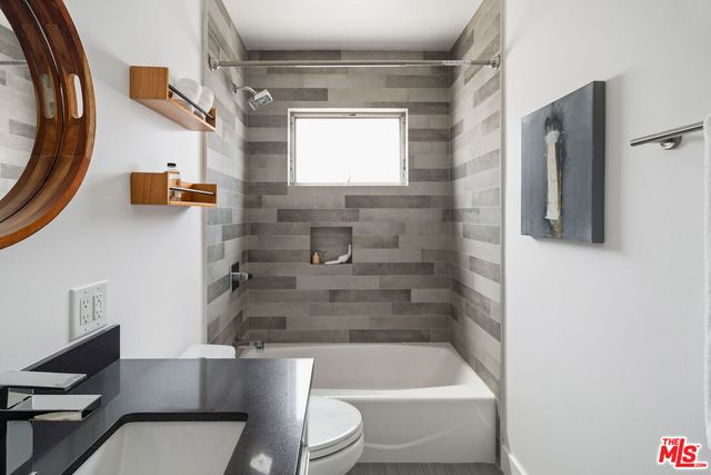 a bedroom with a bed and a desk