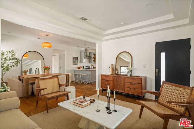 a living room with furniture a rug and a window