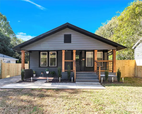 a view of a house with pool and sitting area