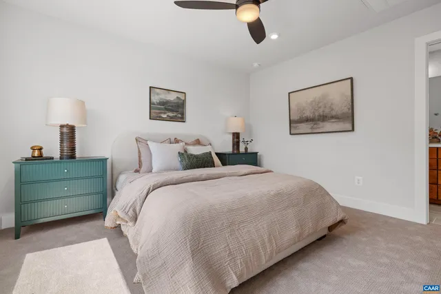 a bedroom with a bed and a painting on the wall