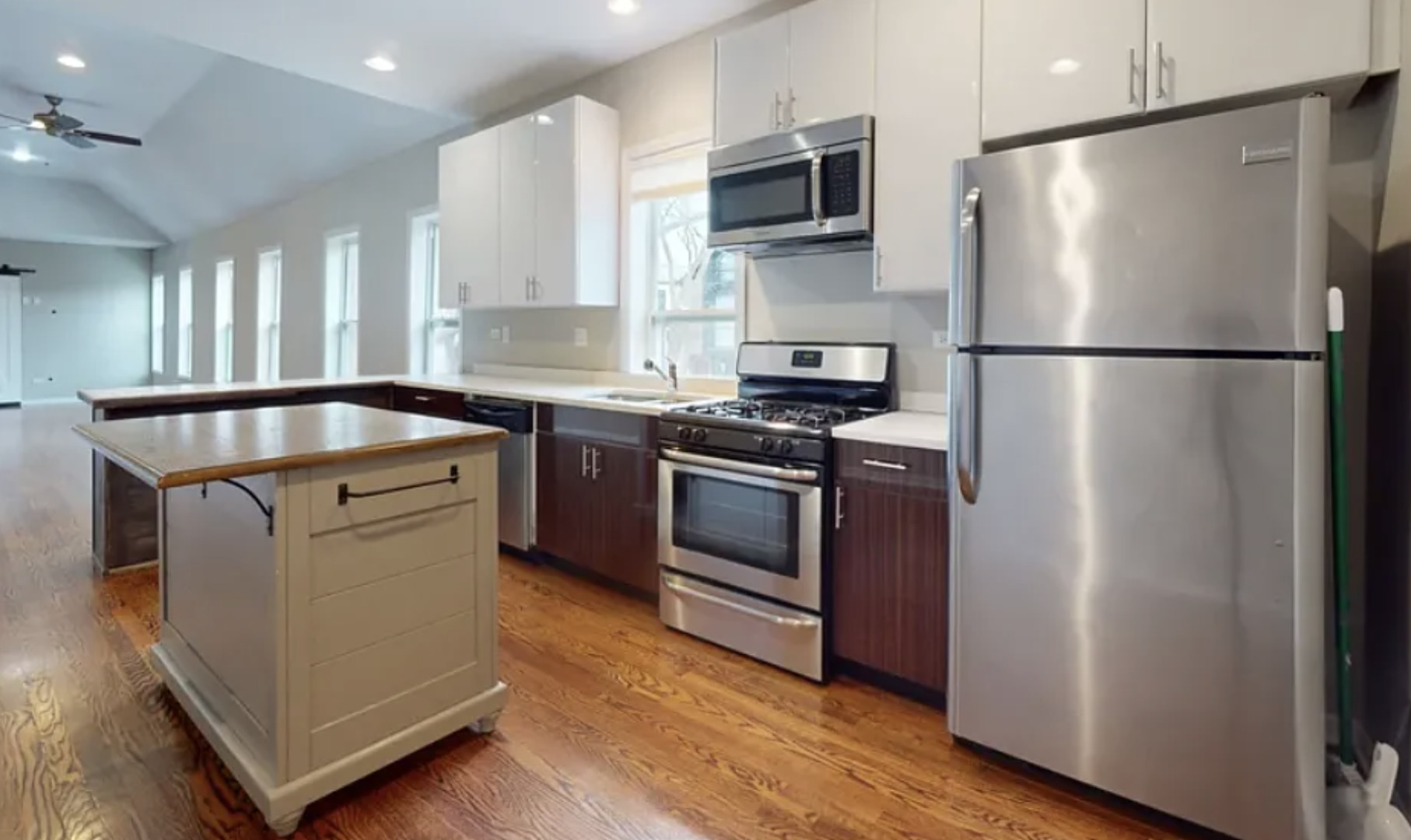2101 West Fletcher Street, Unit 2F Chicago, IL 60618 - Photo 3 of 8 a kitchen with stainless steel appliances granite countertop a stove a refrigerator and a microwave