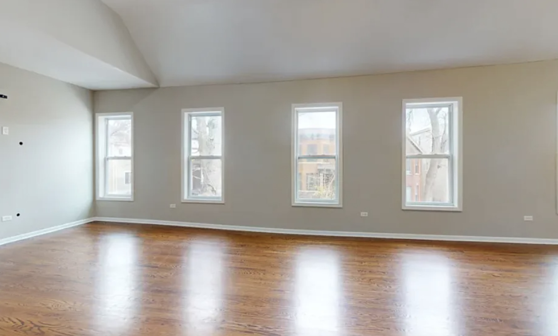 2101 West Fletcher Street, Unit 2F Chicago, IL 60618 - Photo 5 of 8 a view of an empty room with wooden floor and a window