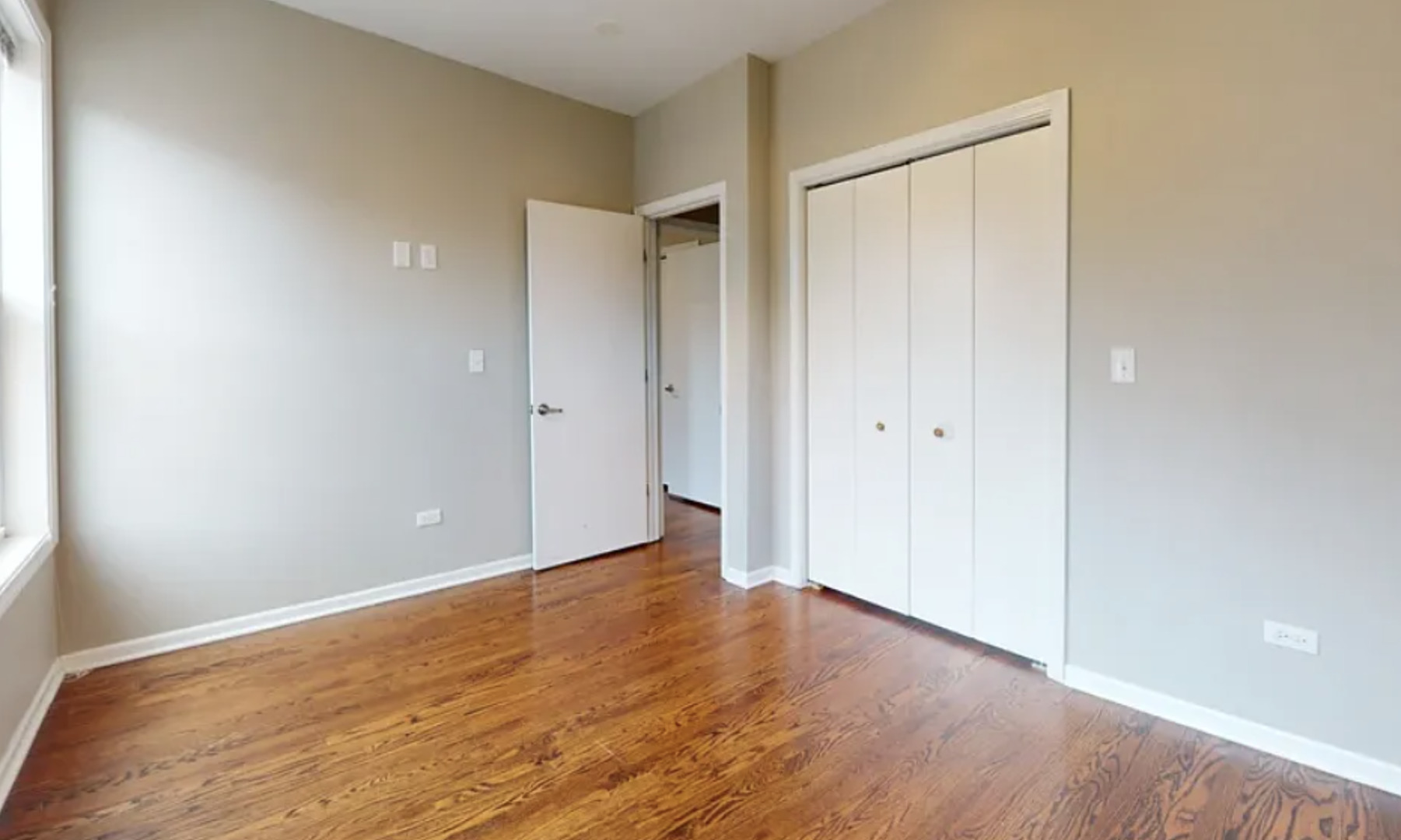 2101 West Fletcher Street, Unit 2F Chicago, IL 60618 - Photo 7 of 8 a view of an empty room with wooden floor