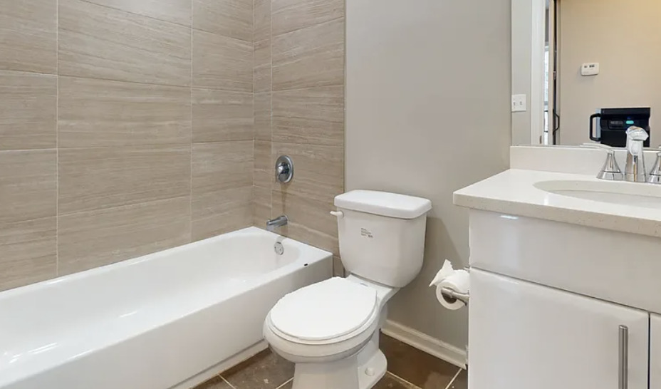 2101 West Fletcher Street, Unit 2F Chicago, IL 60618 - Photo 8 of 8 a white toilet sitting next to a bathroom sink