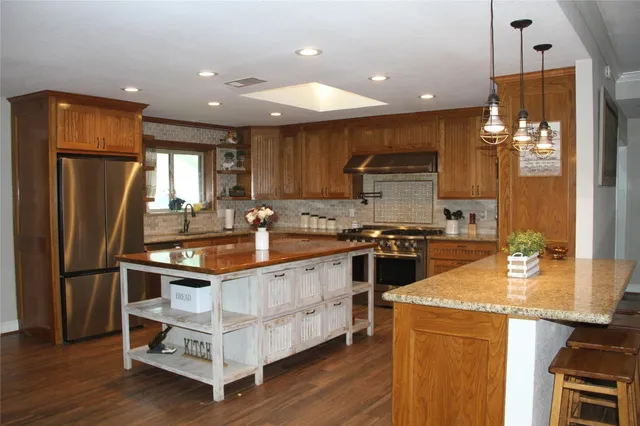 a kitchen with a sink stove and refrigerator