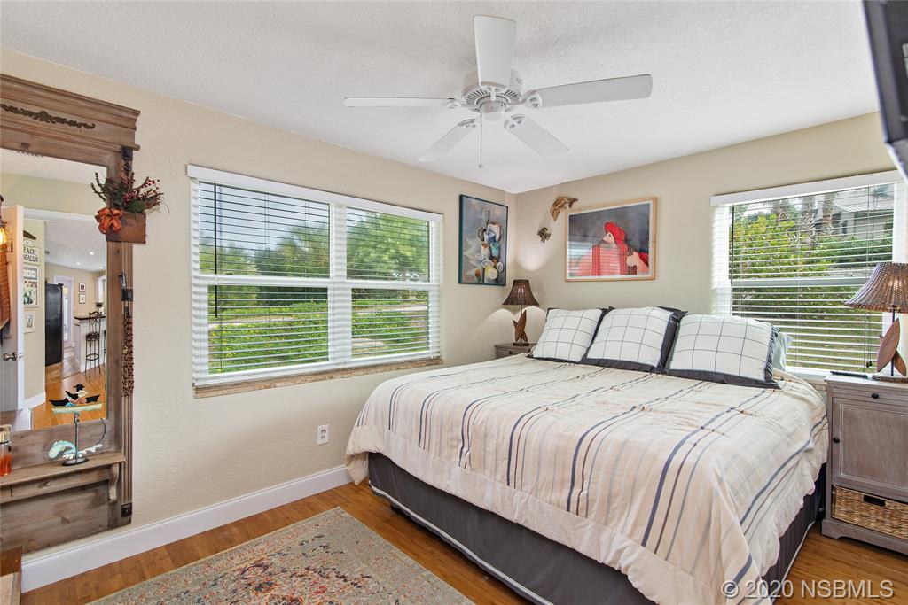 405 Tide Street New Smyrna Beach, FL 32169 - Photo 13 of 33 a bedroom with a bed and a window