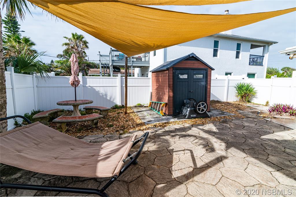 405 Tide Street New Smyrna Beach, FL 32169 - Photo 17 of 33 a front view of a house with garden