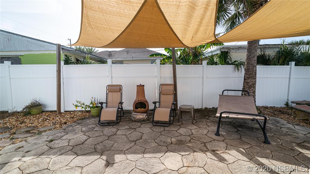 405 Tide Street New Smyrna Beach, FL 32169 - Photo 18 of 33 a outdoor space with lots of tables and chairs