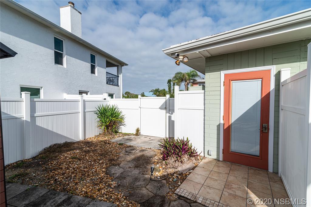 405 Tide Street New Smyrna Beach, FL 32169 - Photo 19 of 33 a front view of a house with a yard