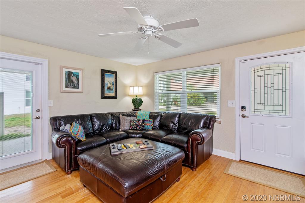405 Tide Street New Smyrna Beach, FL 32169 - Photo 3 of 33 a living room with furniture and a window