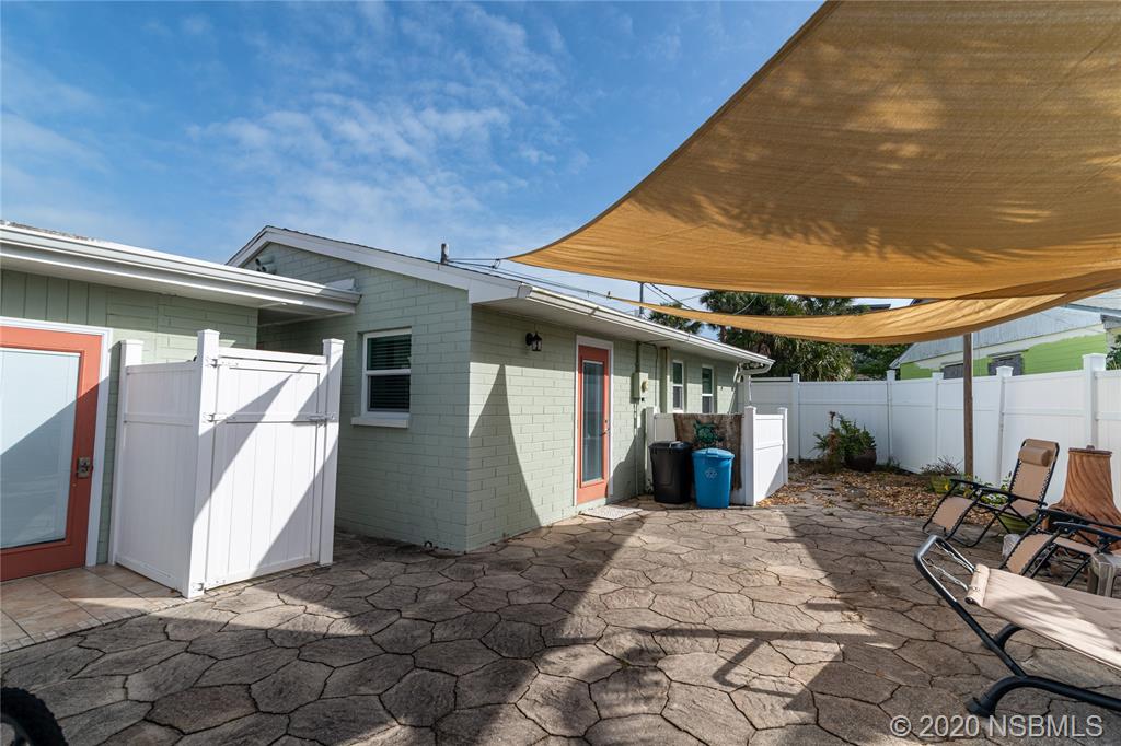 405 Tide Street New Smyrna Beach, FL 32169 - Photo 21 of 33 a backyard of a house with seating space