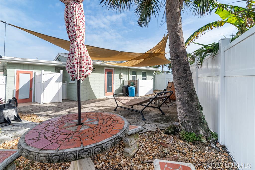 405 Tide Street New Smyrna Beach, FL 32169 - Photo 22 of 33 a front view of a house with garden