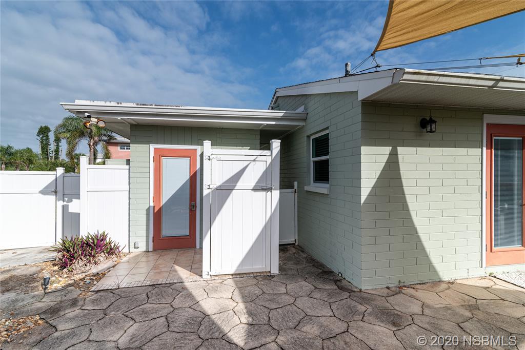 405 Tide Street New Smyrna Beach, FL 32169 - Photo 23 of 33 a view of a house with a garage
