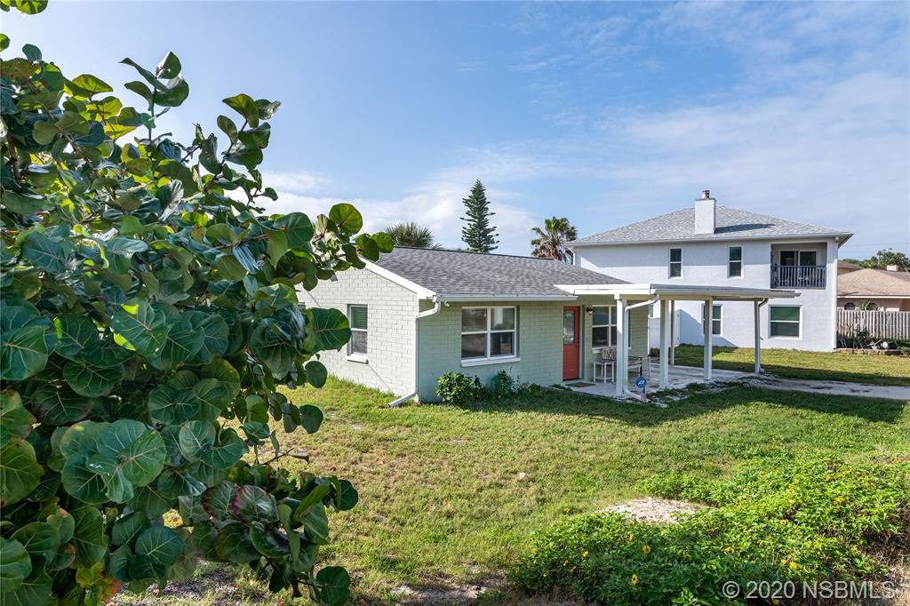 405 Tide Street New Smyrna Beach, FL 32169 - Photo 28 of 33 a front view of a house with garden