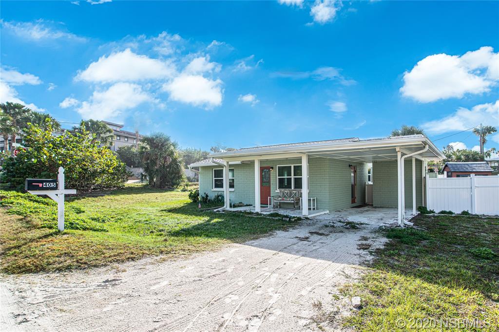 405 Tide Street New Smyrna Beach, FL 32169 - Photo 29 of 33 a view of a house with backyard and a tree