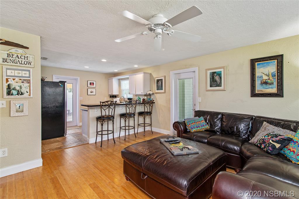 405 Tide Street New Smyrna Beach, FL 32169 - Photo 4 of 33 a living room with furniture and a table