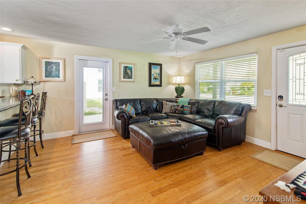 405 Tide Street New Smyrna Beach, FL 32169 - Photo 5 of 33 a living room with furniture and wooden floor
