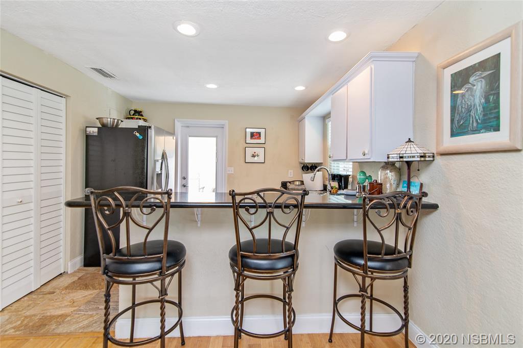 405 Tide Street New Smyrna Beach, FL 32169 - Photo 6 of 33 a view of a dining room with chairs and a table