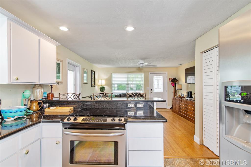405 Tide Street New Smyrna Beach, FL 32169 - Photo 10 of 33 a kitchen with a stove and cabinets
