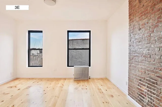 a bedroom with a bed and a television