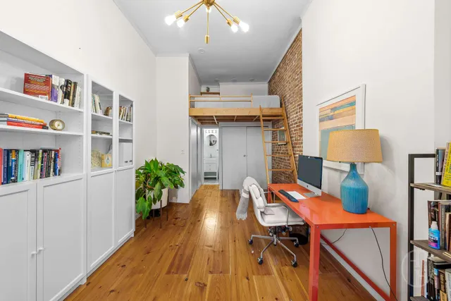 a living room with furniture a fireplace and a chandelier