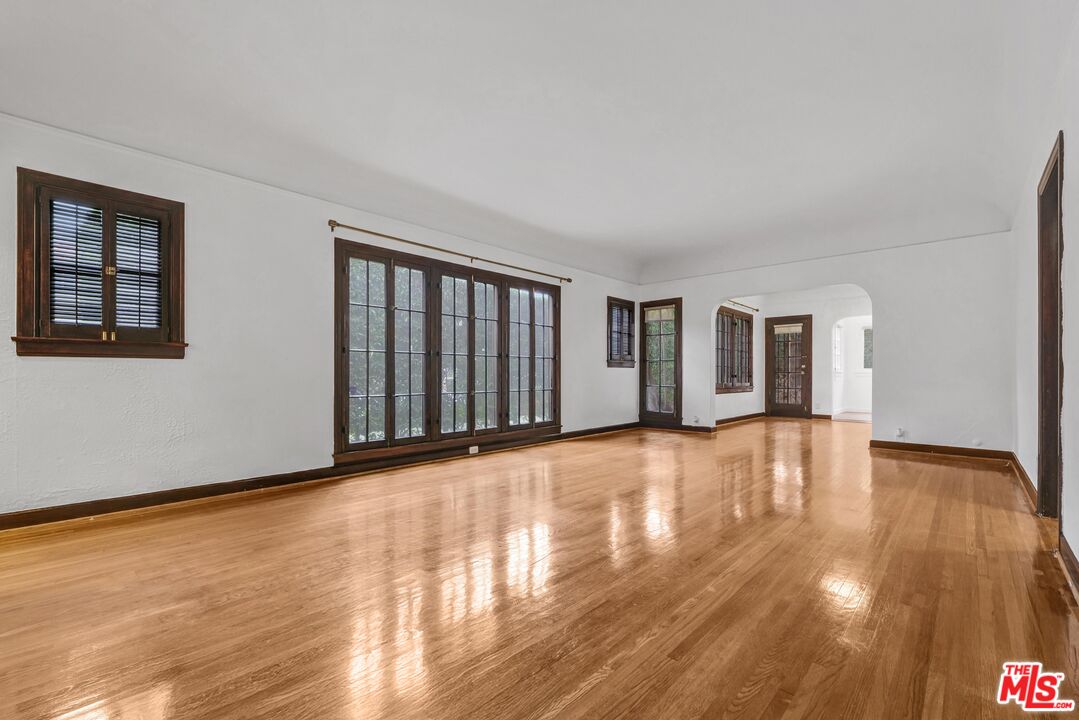 5112 Edgewood Place Los Angeles, CA 90019 - Photo 12 of 21 a view of an empty room with wooden floor and a window