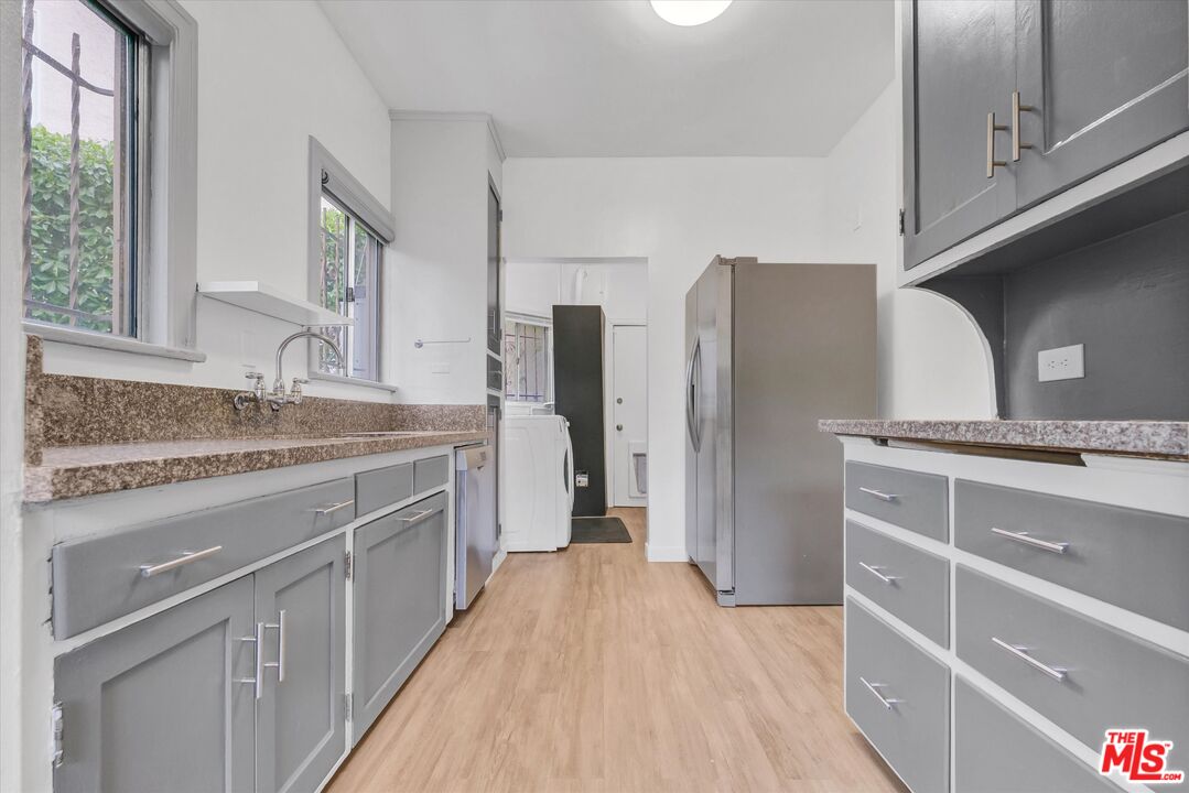 5112 Edgewood Place Los Angeles, CA 90019 - Photo 16 of 21 a kitchen with stainless steel appliances granite countertop a sink and refrigerator