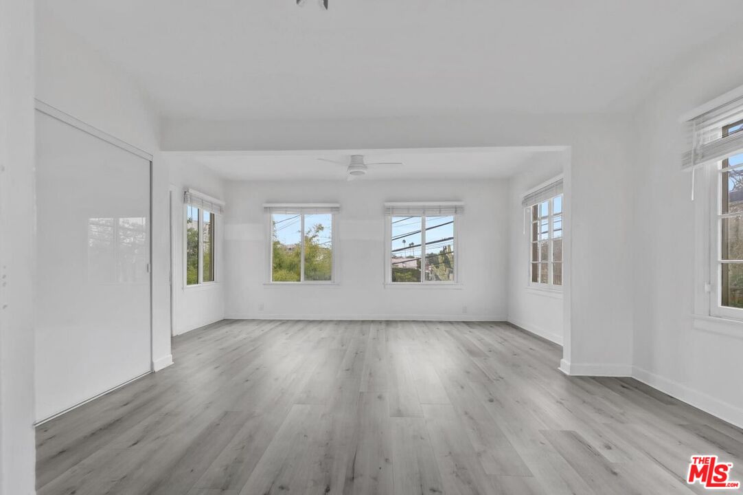 5112 Edgewood Place Los Angeles, CA 90019 - Photo 6 of 21 an empty room with wooden floor and windows