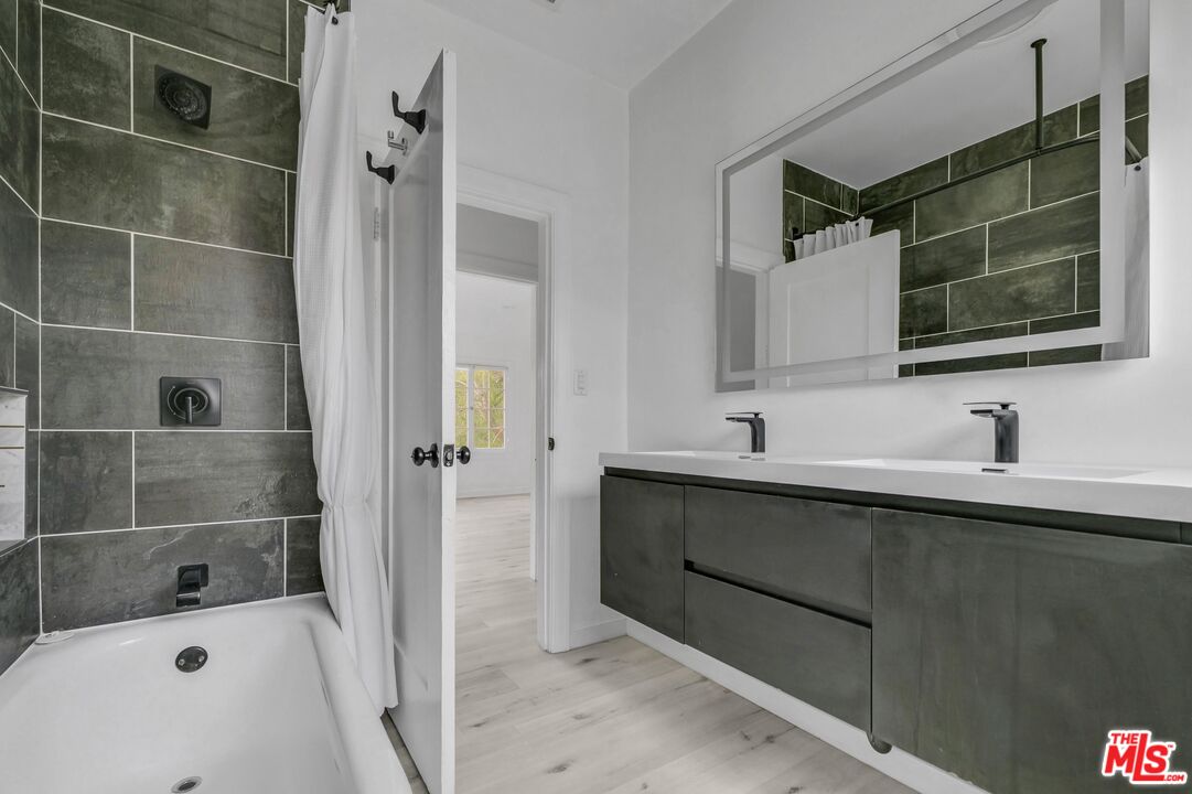 5112 Edgewood Place Los Angeles, CA 90019 - Photo 8 of 21 a bathroom with a sink and a mirror