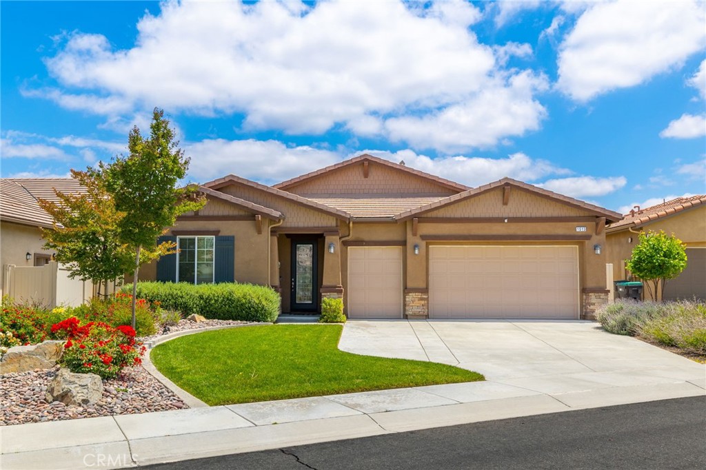 a front view of a house with a garden and plants