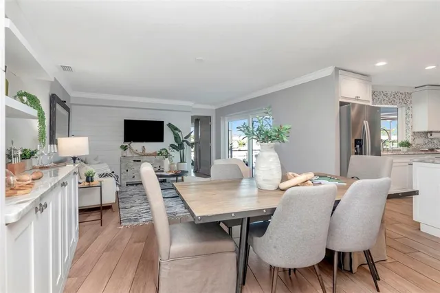 a bedroom with a bed and a flat tv screen on dresser