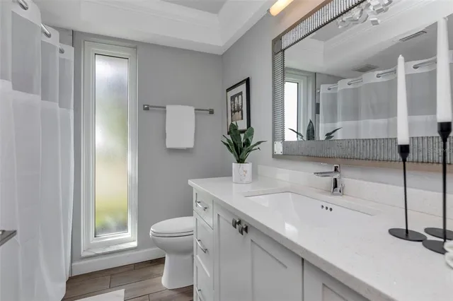 an aerial view of a swimming pool with lawn chairs