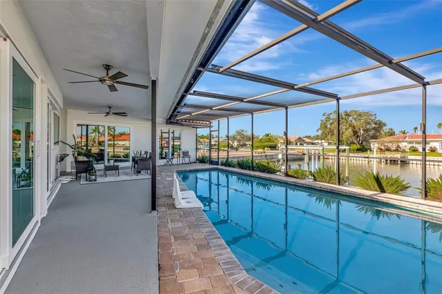 an aerial view of a house with a yard lake view and mountain view in back