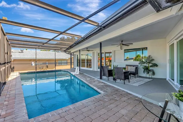an aerial view of a city with lots of residential buildings ocean and mountain view in back