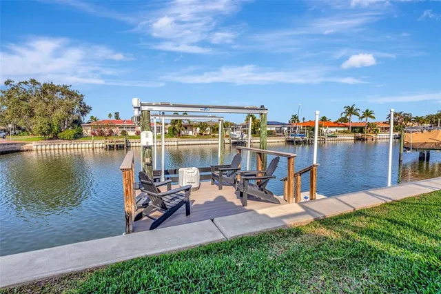 an aerial view of a city with lots of residential buildings ocean and ocean view in back