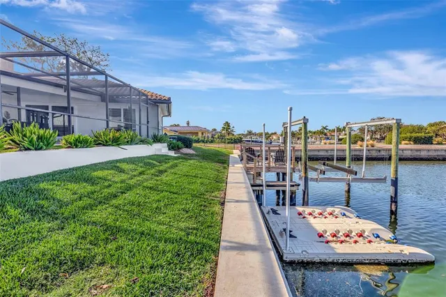 an aerial view of a residential houses with outdoor space and trees