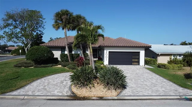 an aerial view of ocean and residential houses with outdoor space