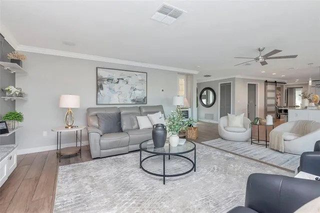 a kitchen with stainless steel appliances kitchen island granite countertop a refrigerator and a sink