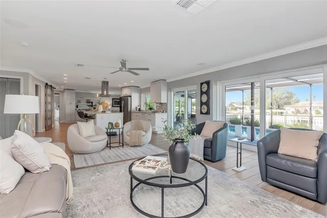 a kitchen with kitchen island granite countertop a sink appliances and cabinets