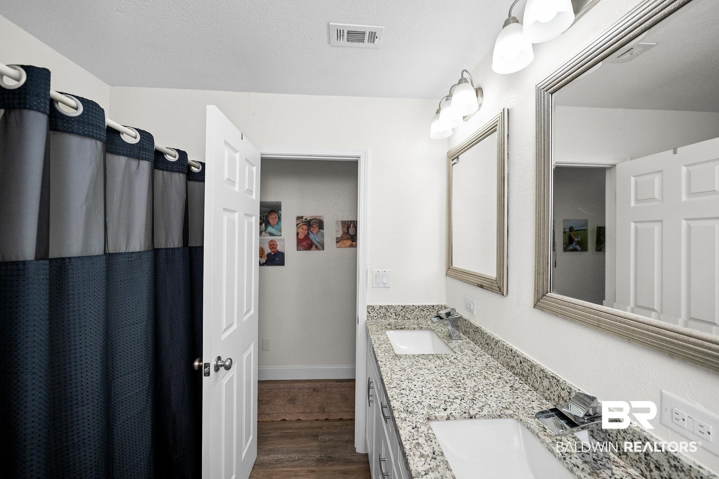 33129 Antietam Road Lillian, AL 36549 - Photo 13 of 31 Double vanity featuring a light speckled countertop, dual undermount sinks, and chrome faucets