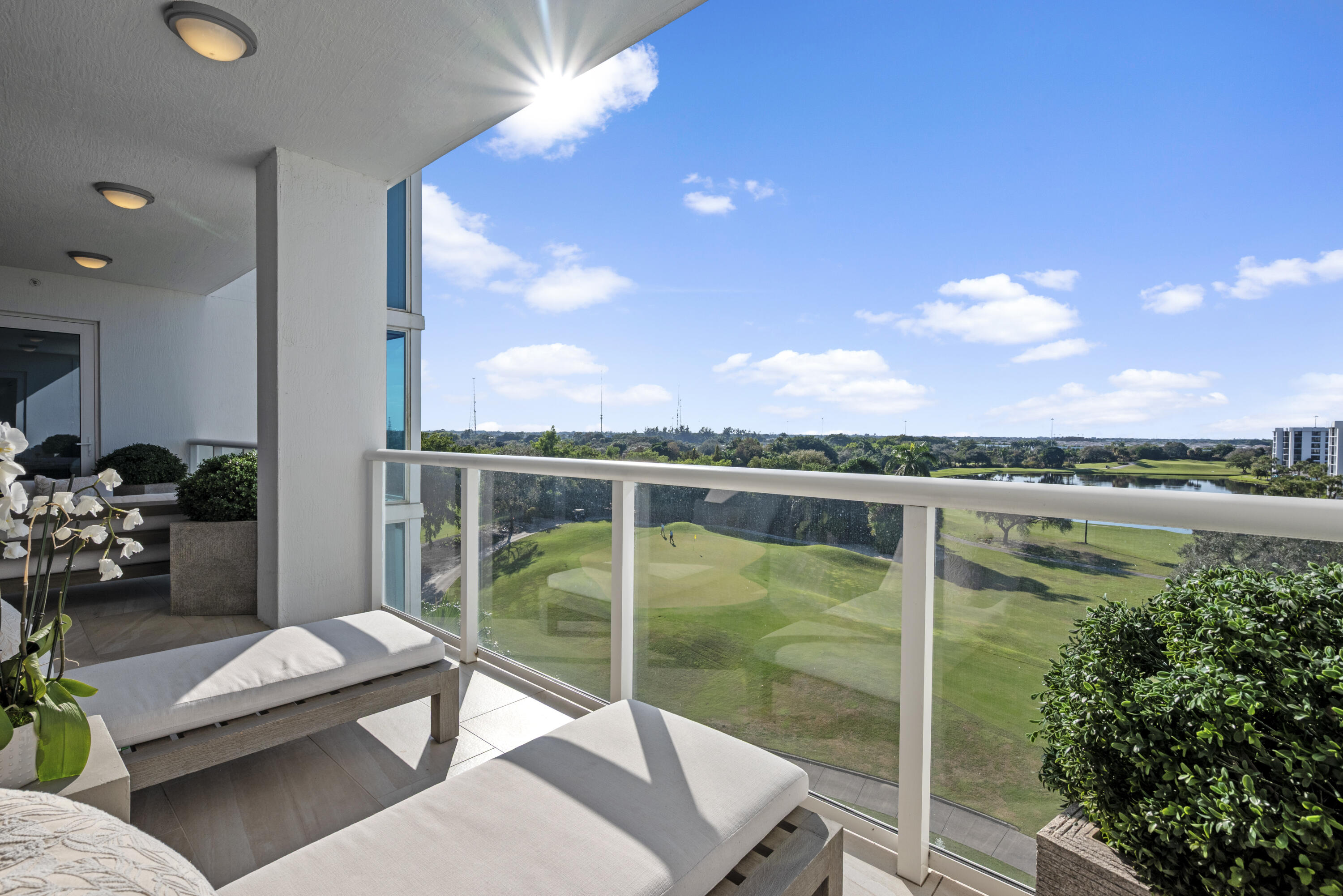 20155 Boca W Drive, Unit C504 Boca Raton, FL 33434 - Photo 13 of 42 a view of a balcony with lake view and a potted plant