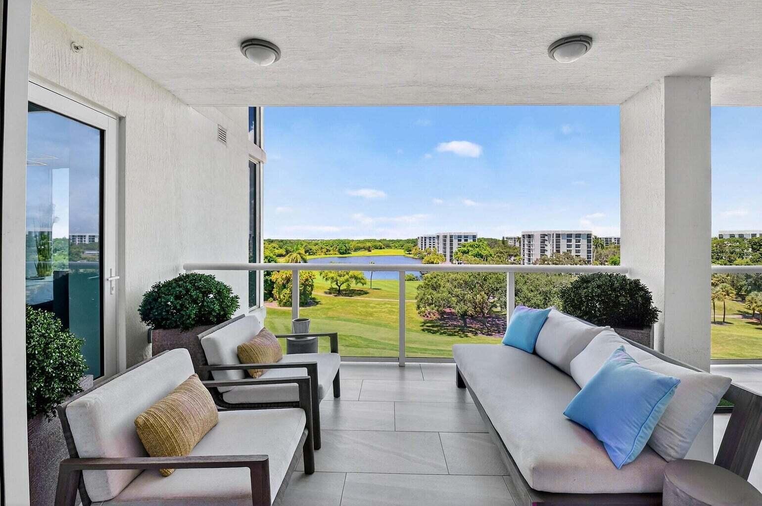 20155 Boca W Drive, Unit C504 Boca Raton, FL 33434 - Photo 14 of 42 a living room with furniture floor to ceiling window and wooden floor