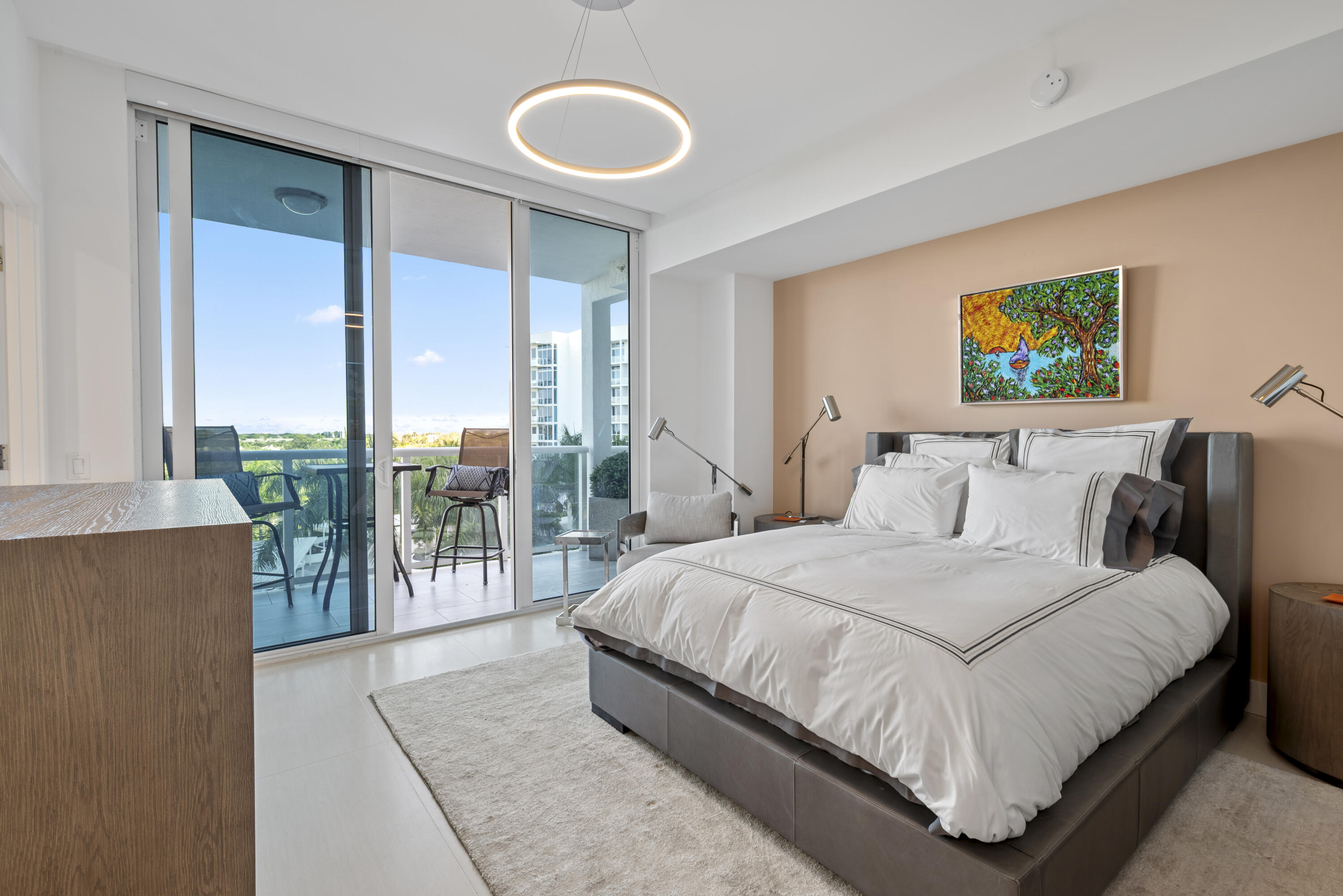 20155 Boca W Drive, Unit C504 Boca Raton, FL 33434 - Photo 24 of 42 a bedroom with a bed a lamp and large window