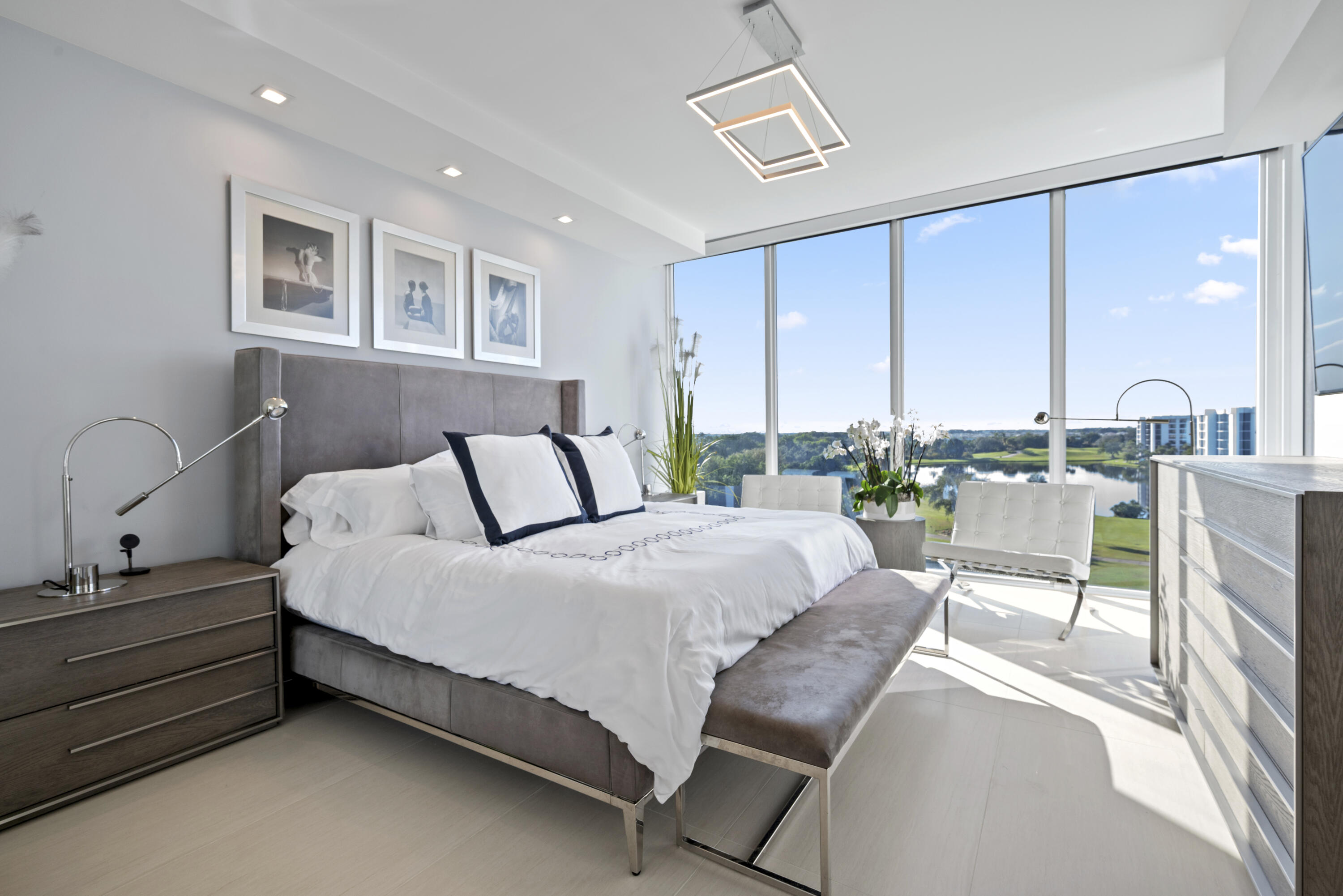 20155 Boca W Drive, Unit C504 Boca Raton, FL 33434 - Photo 9 of 42 a bedroom with a bed a table and chairs