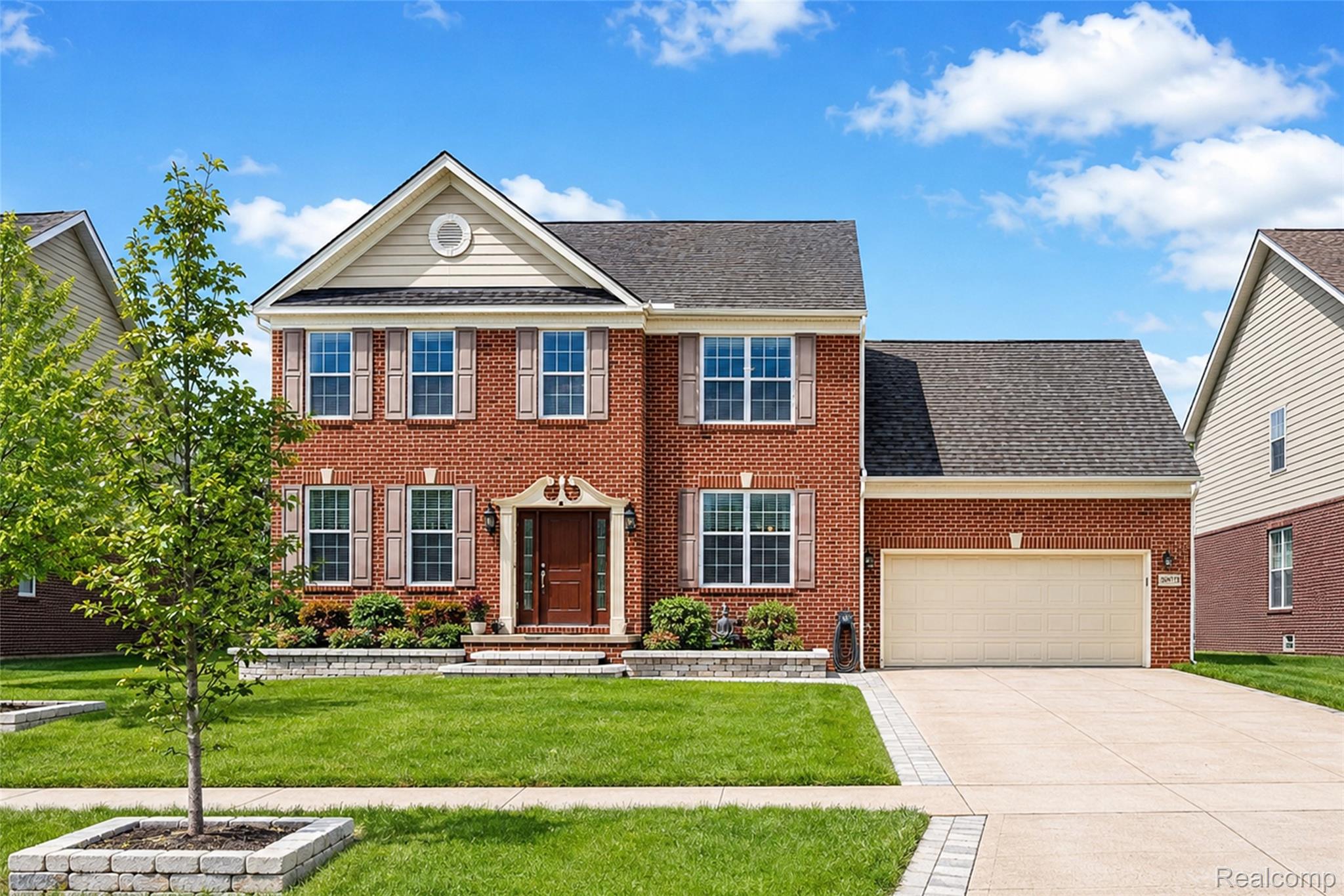 50873 Scarborough Road Canton, MI 48188 - Photo 1 of 33 Brick-front residence featuring a prominent gabled entry with an arched window accent