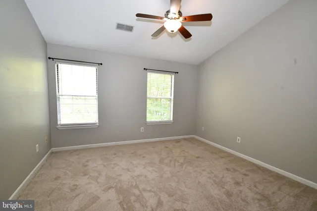a view of room with a ceiling fan and window