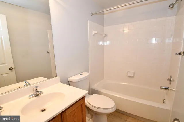 a bathroom with a sink mirror toilet and bathtub