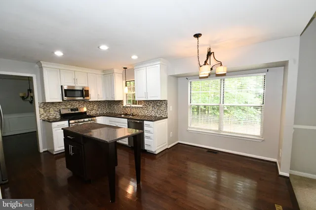a kitchen with granite countertop counter top space a sink appliances and cabinets