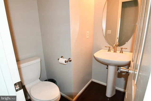 a bathroom with a sink toilet and a mirror