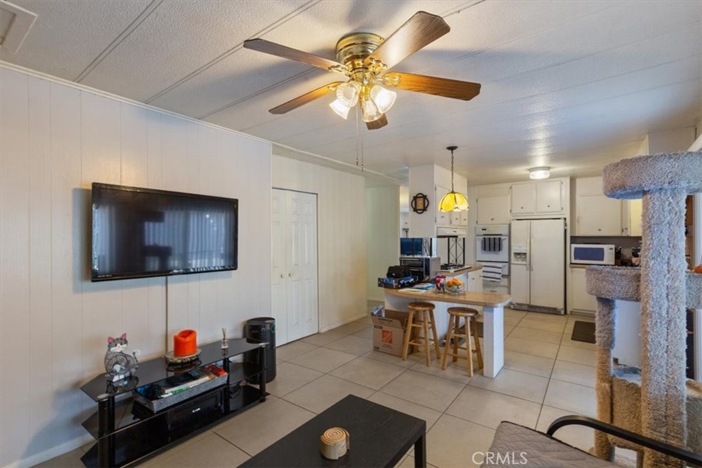 300 North Rampart Street, Unit 195 Orange, CA 92868 - Photo 8 of 25 a work room with furniture and a flat screen tv
